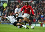 Cristiano Ronaldo of United gets past Sylvain Legwinski of Fulham